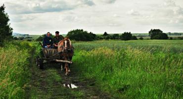 Couple riding through the countryside of Ukraine.